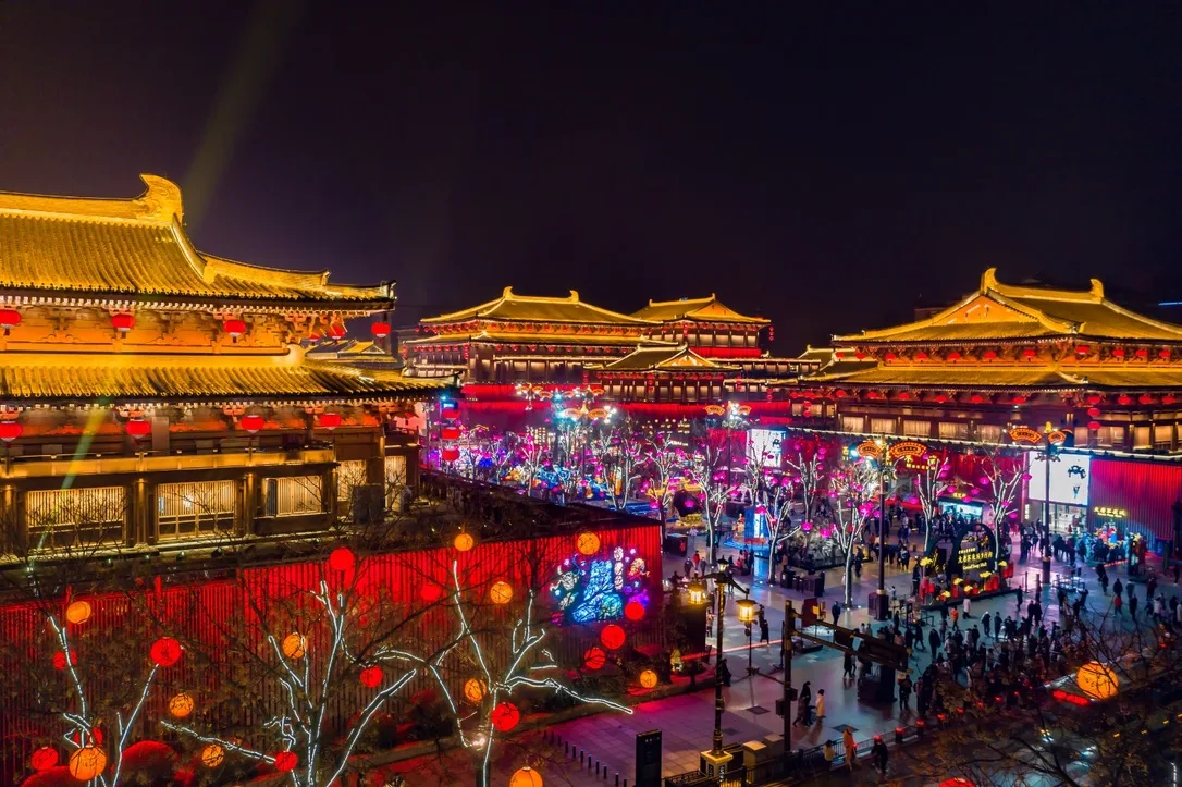 Aerial view of Datang Everbright City at night, lined with lit Tang-style halls