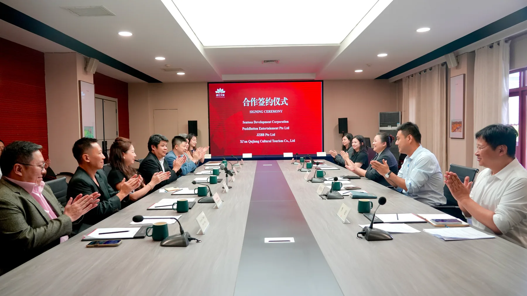 Delegates around a meeting table at the signing ceremony