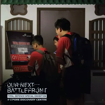 Students at a shophouse doorway set