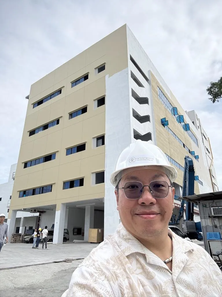 The Super Bean Singapore building under construction, with a team member in a hard hat