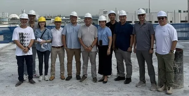 The project team in hard hats at the Super Bean Singapore construction site