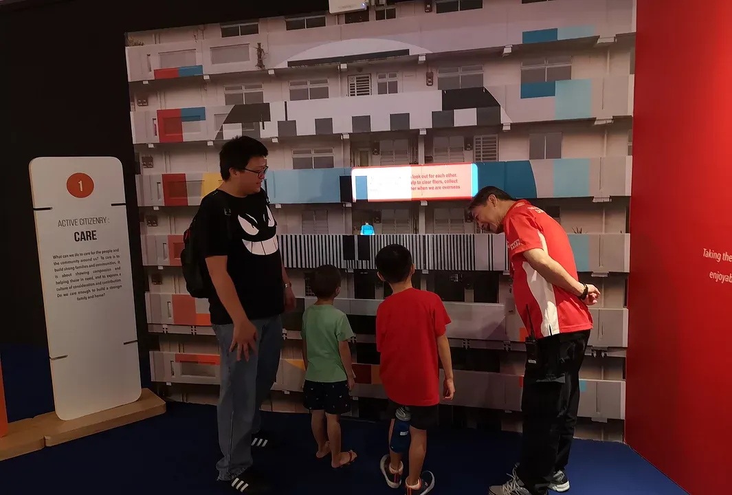 Family at a kampong-style flats display