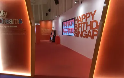 Orange corridor leading to Happy Birthday Singapore lettering