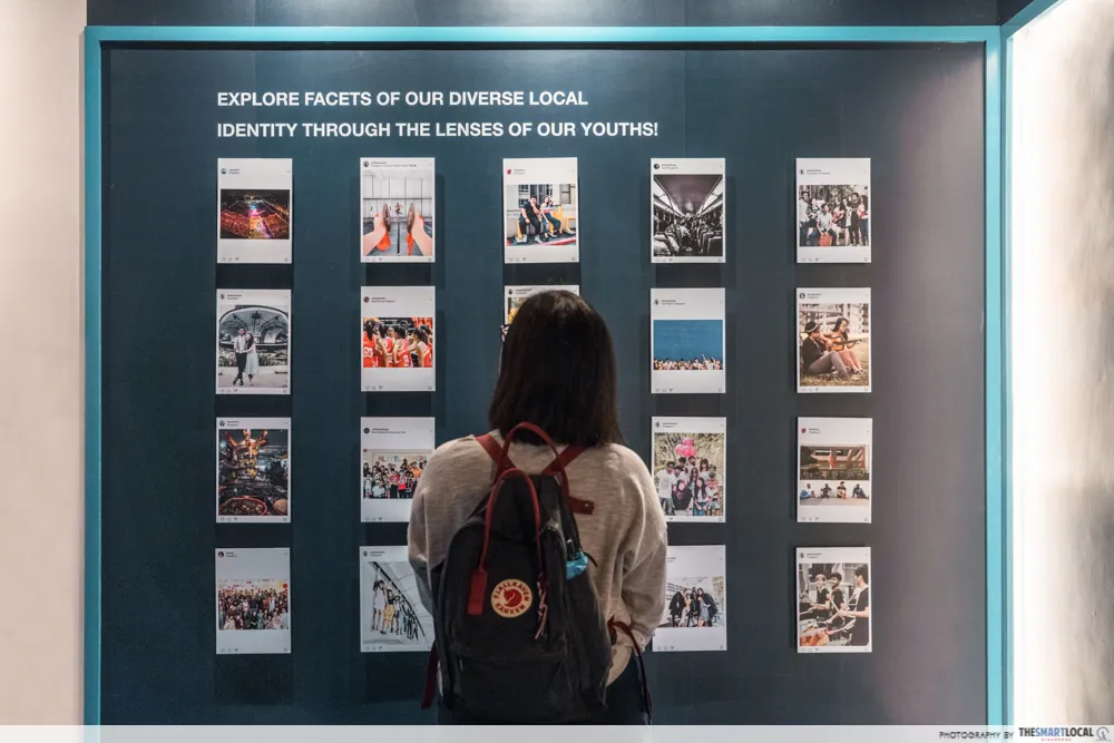 Visitor looking at a wall of youth photographs