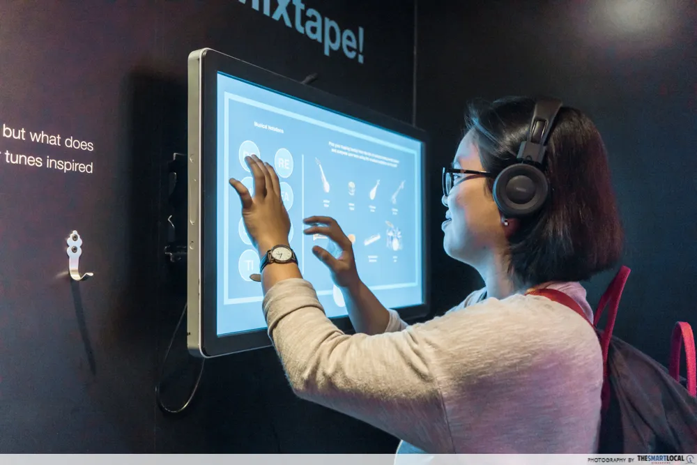 Visitor making a song at a touchscreen mixtape station