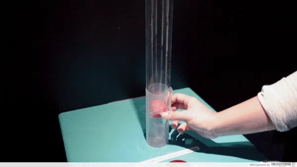 Hand touching an interactive light tube