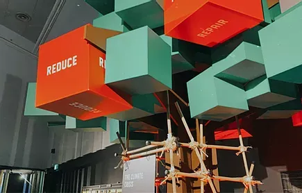 Red and teal block sculpture labelled Reduce and Repair